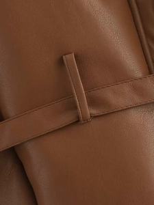Detail of dark brown leather jacket waist belt loop with neat stitching and grain texture