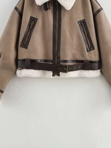 Detailed close-up of camel faux suede jacket with white shearling trim and metal zipper