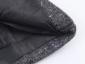 Detail of herringbone wool blazer showing high-quality black silk lining and stitching