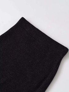 Detail shot of the fine knit texture and high-quality dark grey wool fabric of the skirt
