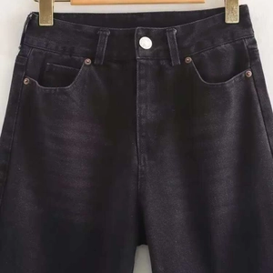 High-waisted dark black straight-leg jeans with vintage wash and side metal rivets
