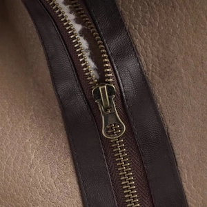 Short double-sided jacket with lapel and vintage bronze zipper on beige lychee leather
