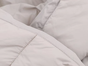 Macro detail of high-density parallel quilting and premium matte windproof fabric texture