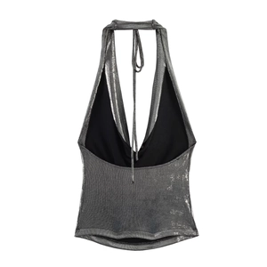 Detail of silver metallic halter neck top featuring shimmer fabric and adjustable neck ties