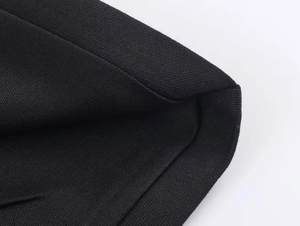 Macro shot of black ribbed knit fabric detailing tight neck and cuff stitching