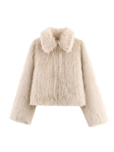 Detail of soft cream faux fur texture with elegant golden metal zipper closure