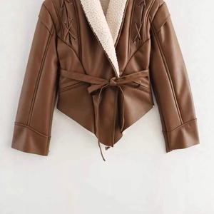 Brown faux leather jacket with cream fleece lining and asymmetric waist tie belt