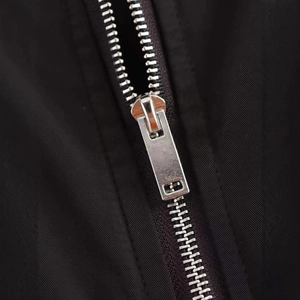 Fashionable black oversized varsity bomber jacket featuring high-density silver metal zippers