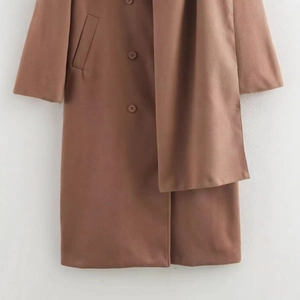 Women's long brown wool coat featuring scarf collar and classic button closure design