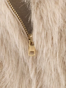 Close-up of golden metal zipper on high-quality beige faux fur winter jacket fabric