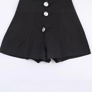 Women's black high-waisted sleeveless romper with square neck and three silver jeweled buttons