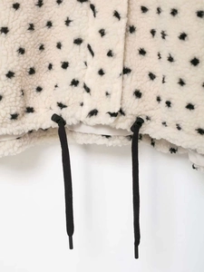 Detail of fleece jacket hem with adjustable black drawstring and star pattern print