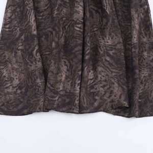 Close-up of the retro abstract print hem and fabric texture of a midi skirt