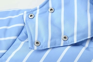 Detail of blue and white striped puffer jacket fabric with silver metal snap buttons