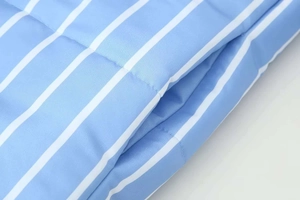 Detail of blue and white vertical stripe pattern and side pocket on a padded winter jacket