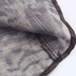 Detailed close-up showing the fine stitching and camo print fabric of the midi skirt