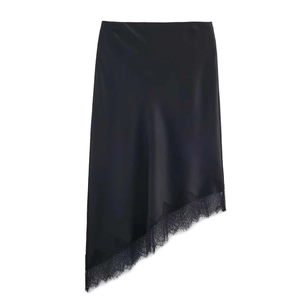 Detail view of black satin midi skirt with asymmetric hem and delicate lace trim