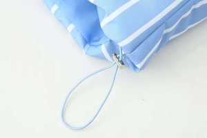 Detail of blue striped puffer jacket sleeve showing elastic drawstring and silver metal toggle