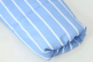 Close-up of blue and white vertical striped fabric texture on puffy winter jacket