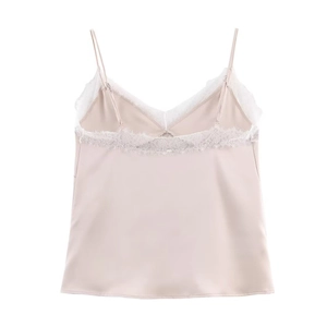 Detailed close-up of pale pink satin camisole featuring delicate white eyelash lace trim