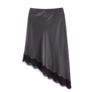 Detail of dark grey satin midi skirt featuring eyelash lace trim and asymmetric hemline