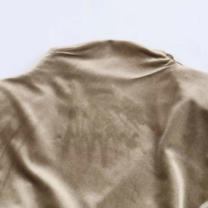 Detail of olive gold velvet dress showing mock neck and luxurious fabric texture