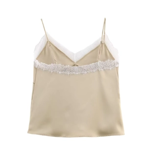 Detail of champagne satin camisole with white floral lace trim and adjustable straps
