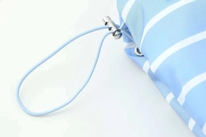 Detail of blue and white striped puffer jacket showing elastic drawstring and silver metal toggle
