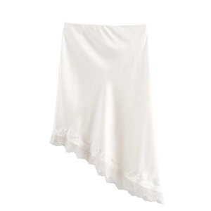 Detail of white satin midi skirt with elegant lace embroidery and irregular hemline