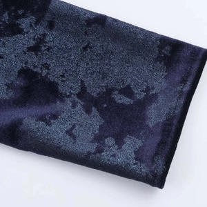 Macro shot of dark blue velvet fabric with metallic sheen and high-quality stitching