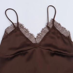 Detail of dark brown satin camisole featuring delicate eyelash lace trim and silk texture
