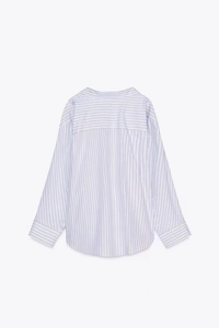 Detail view of the back of a light purple and white striped long-sleeve shirt with back yoke
