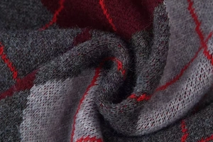 Close-up of vintage argyle knit sweater with grey and dark red geometric diamond patterns