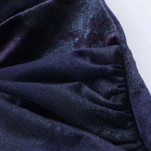 Macro detail of elegant deep purple velvet fabric with shimmering pearlescent finish