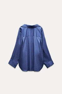 Rear view of a navy blue long-sleeve cotton shirt with back pleat and curved hemline