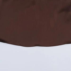 Close-up of the smooth hemline and fine stitching on chocolate brown satin camisole