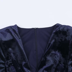Elegant navy blue velvet dress featuring a deep V-neckline and rich embossed texture