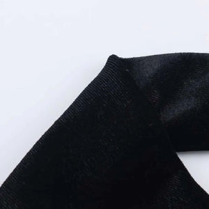 Detailed macro view of premium black velvet and striped fabric texture for dresses