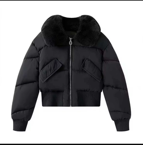 Detail of women's black puffer jacket featuring a detachable faux fur collar and zip closure