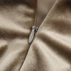Detailed close-up of champagne velvet fabric with seamless invisible zipper closure