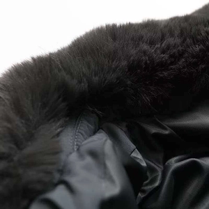 Detail of detachable faux fur collar on black winter jacket with thick woven lining