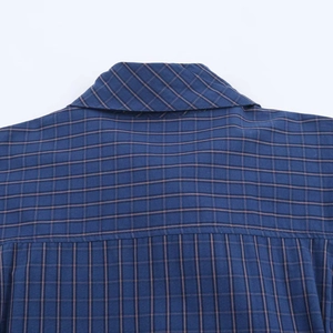 Close-up of navy and tan plaid shirt collar with detailed back yoke stitching detail