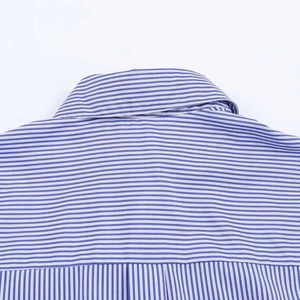 Detailed view of high-quality stitching and blue striped pattern on the shirt neckline