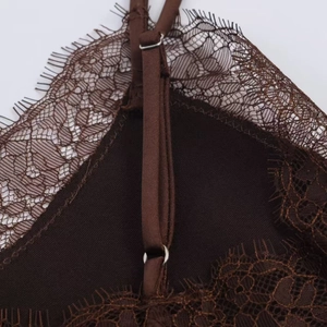 Close-up of brown satin top showing eyelash lace trim and adjustable metal strap slider