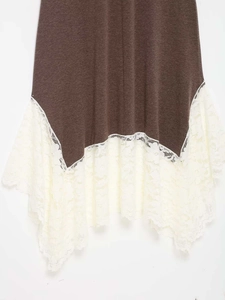 Detailed view of dark brown knit dress hem with delicate cream lace patchwork embroidery