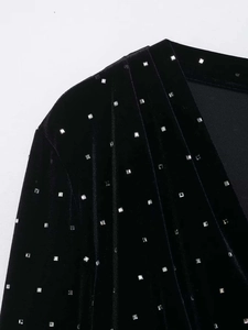 Detail of black velvet midi skirt with silver beaded embellishments and square rhinestones
