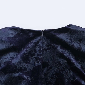Close-up of invisible zipper and embossed velvet texture on elegant evening dress