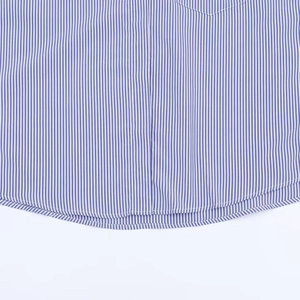 Close-up of curved hem and stitching detail on blue and white striped loungewear top