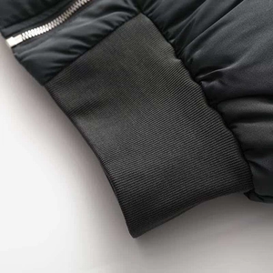 Detail of high-density ribbed cuff and premium silver metal zipper on winter jacket