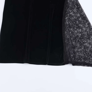 Detail of elegant black velvet fabric stitched with exquisite floral lace patterns